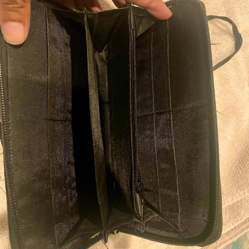 Small colorful purse. Has pocket for cell phone and a zipped up wallet for cards